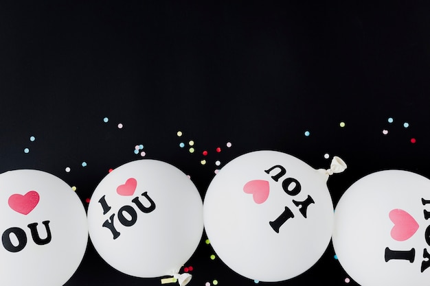 Free photo flat lay frame with balloons and black background