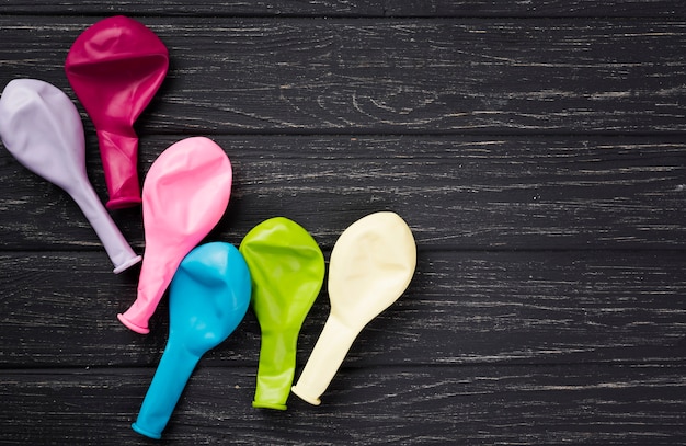 Flat lay frame with balloons on wooden background