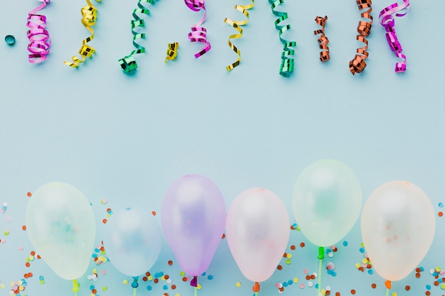 Flat lay frame with confetti and blue background