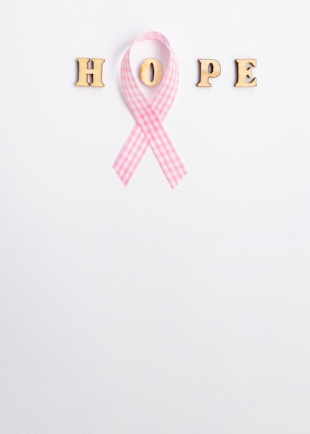 Free photo flat lay frame with pink ribbon and copy-space