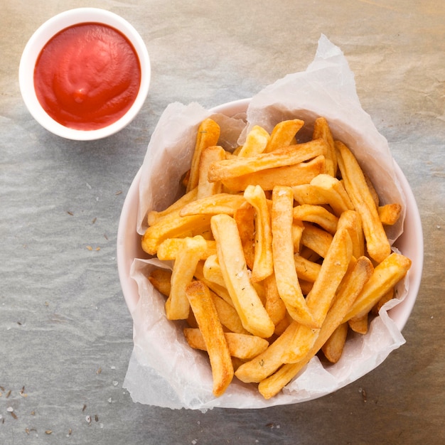 Free Photo flat lay of french fries in bowl with ketchup sauce