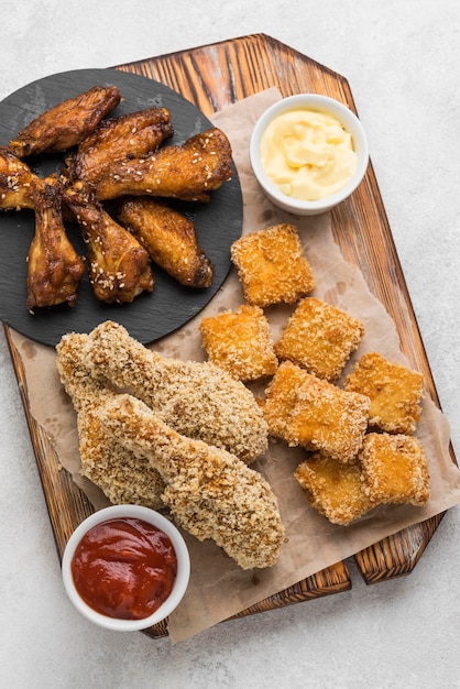 Free photo flat lay of fried chicken and nuggets with two different sauces