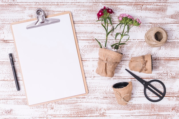 Flat lay gardening concept with clipboard