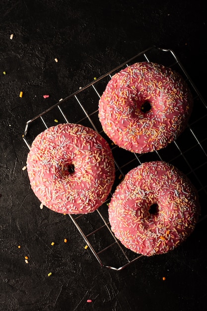 Flat lay of glazed doughnuts decorated with sprinkles