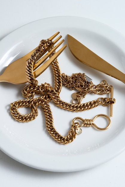 Flat lay gold chains and cutlery