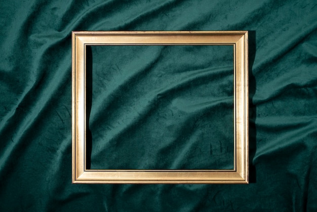 Flat lay golden frame on green background