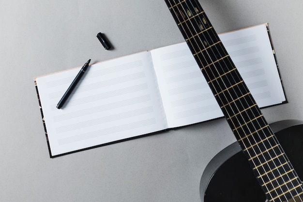 Free photo flat lay of guitar and music notes