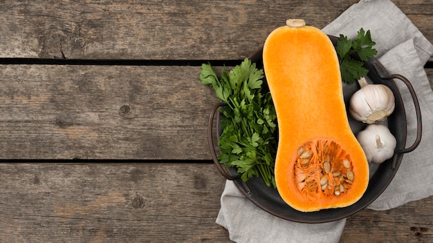 Flat lay halved pumpkin composition with copy space