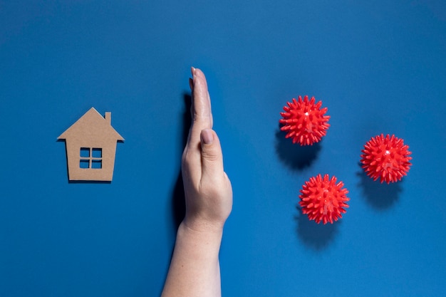 Free photo flat lay of hand protecting house from viruses