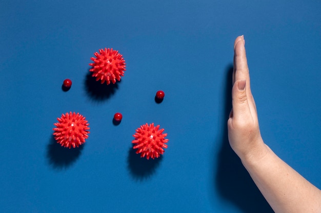 Free photo flat lay of hand stopping viruses