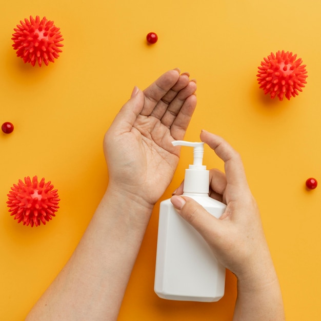 Free Photo flat lay of hands using liquid soap with viruses