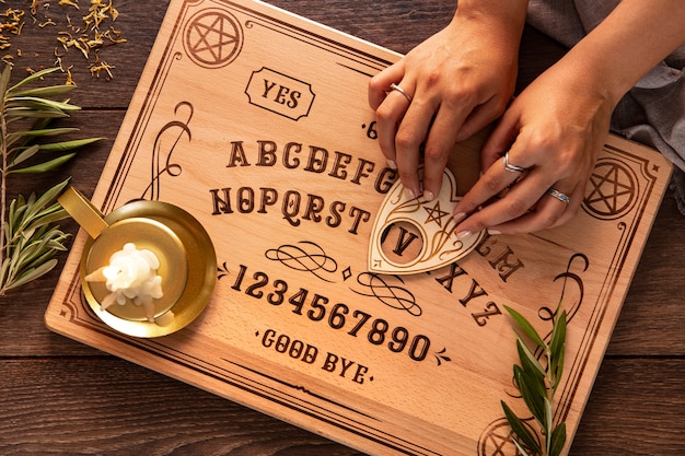 Flat lay hands using ouija board tool