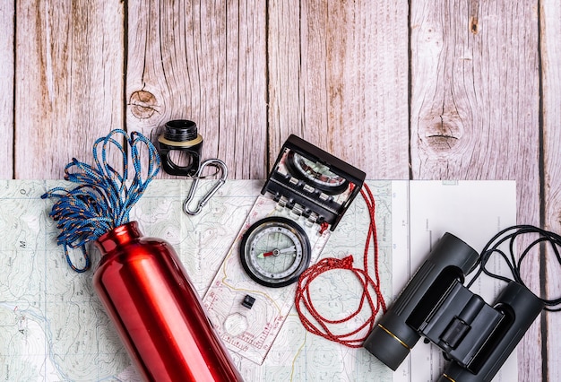 Free photo flat lay of hiking equipment on the wooden surface