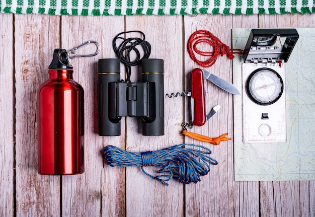 Free photo flat lay of hiking equipment on the wooden surface