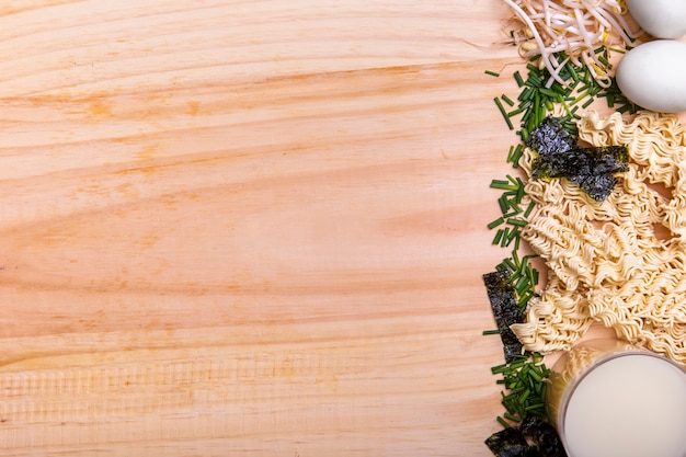 Flat lay ingredients for ramen soup with copy space