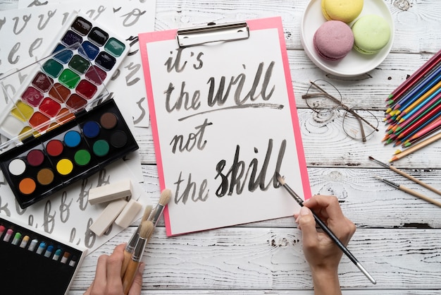 Free Photo flat lay of it's the will not the skill inspirational quote on notepad with color palette