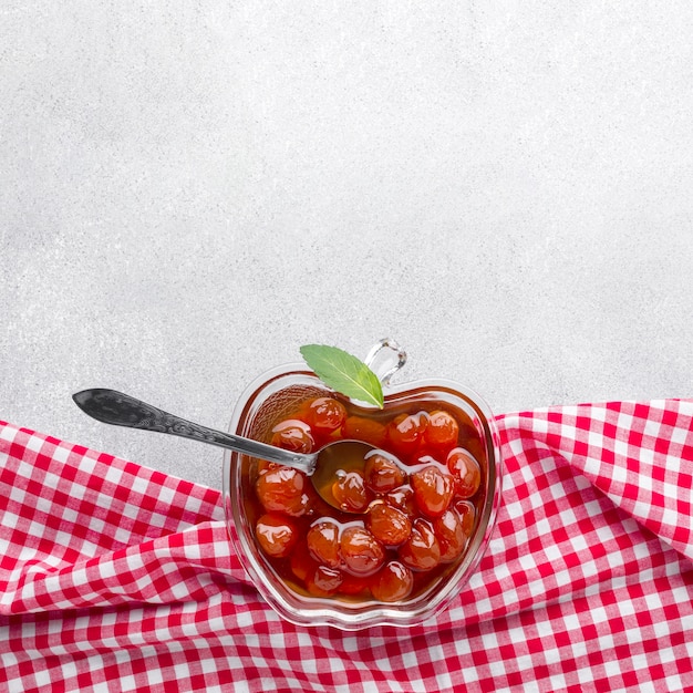 Free photo flat lay jam in apple shaped bowl