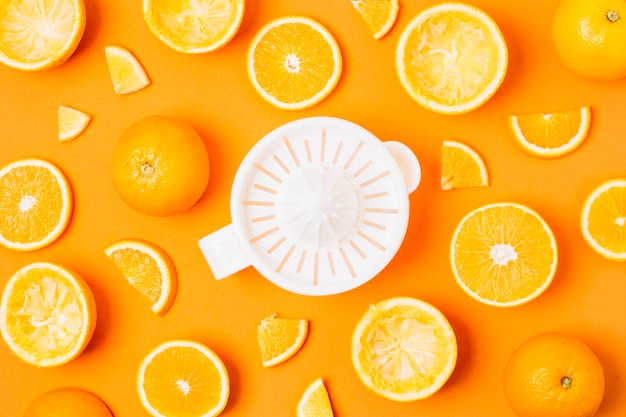 Free Photo flat lay juicer with arrangement of oranges