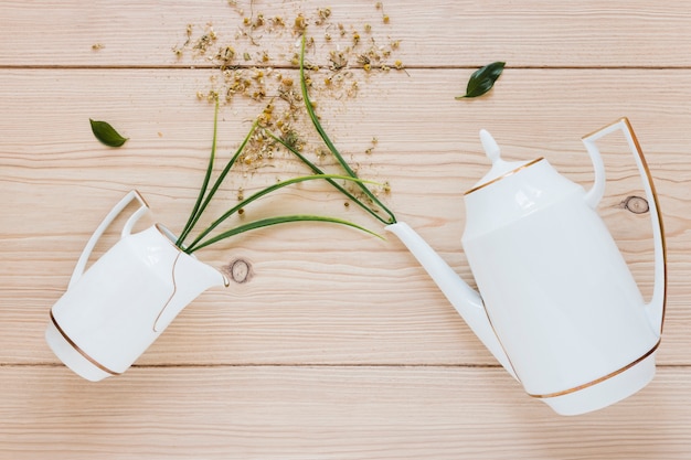 Free Photo flat lay of kettle on wooden table