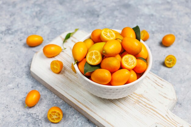 Flat lay of kumquats on a concrete surface