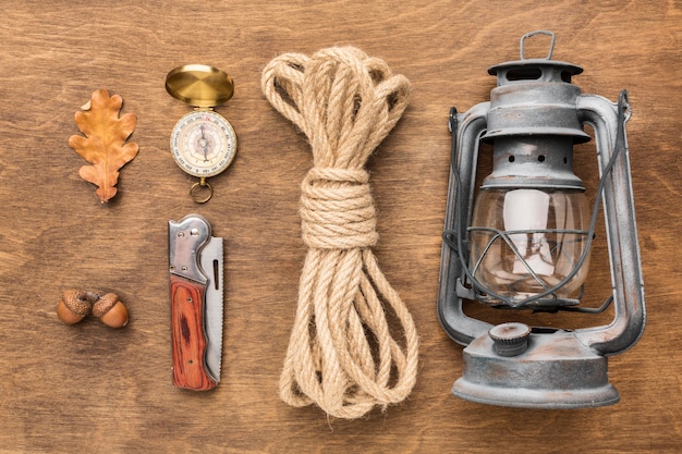 Free photo flat lay of lantern with rope and autumn leaves