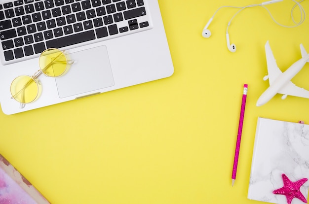 Flat lay of laptop on yellow background