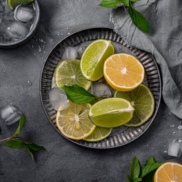 Flat lay lime and lemon slices on plate