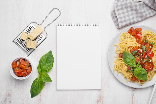 Flat lay local food meal arrangement with notepad