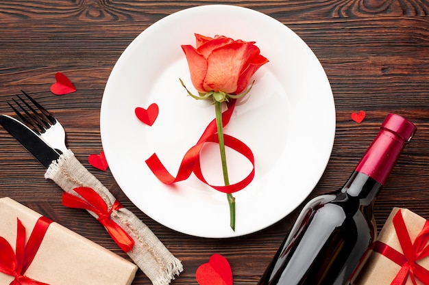 Flat lay lovely arrangement for valentines day dinner on wooden background