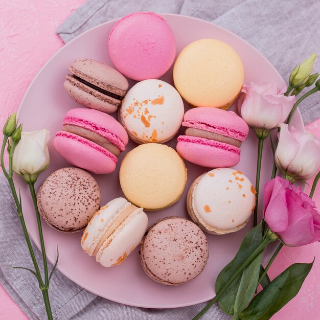 Flat lay of macarons on plate with roses