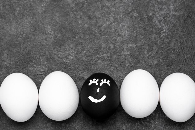 Flat lay of many different colored eggs with faces for black lives matter movement