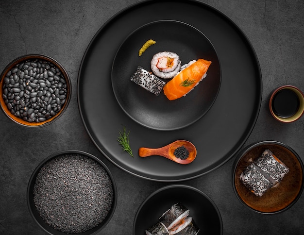 Free Photo flat lay mix of sushi on black plate