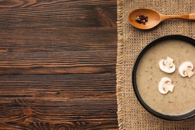 Flat lay mushrooms bisque and spoon with copy space