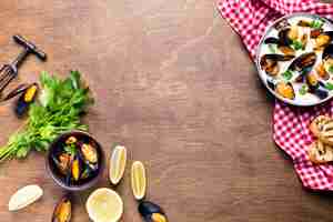 Free photo flat-lay mussels in white sauce on tablecloth with copyspace