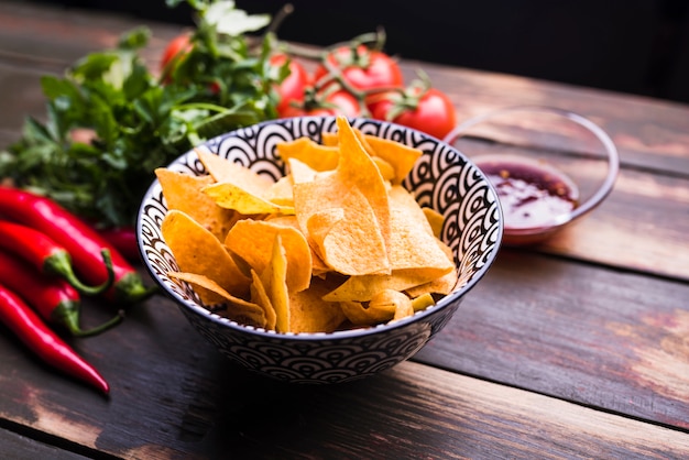 Flat lay of nachos, vegetables and ketchup