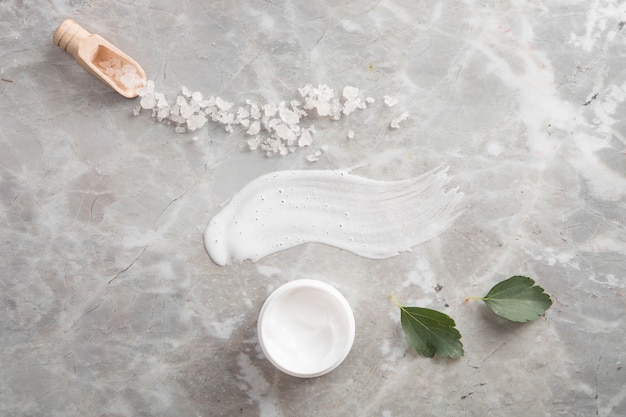 Flat lay of natural cream on marble background