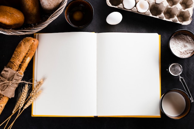 Free photo flat lay of notebook and bread ingredients