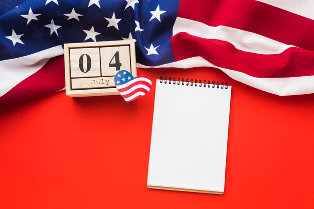 Free Photo flat lay of notebook with american flag and date