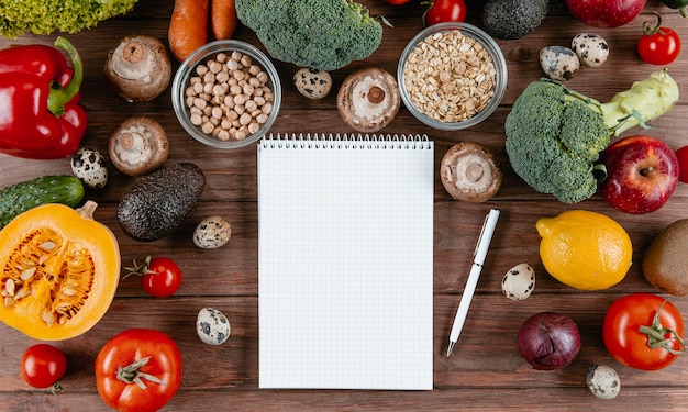 Free photo flat lay of notebook with assortment of vegetables