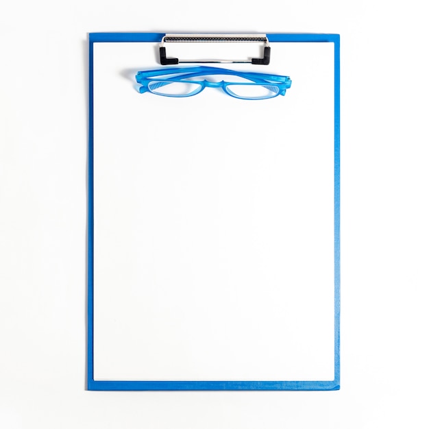 Free photo flat lay of notepad with glasses on top