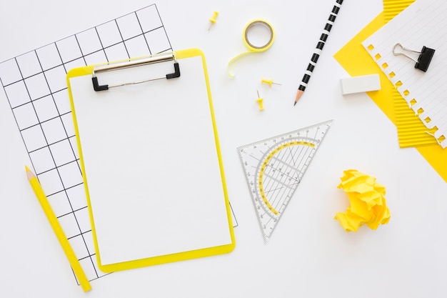 Free photo flat lay of office stationery with notepad and crumpled paper