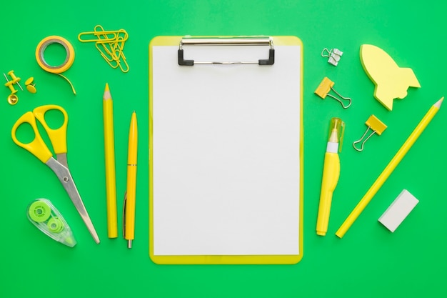 Flat lay of office stationery with notepad and paper clips