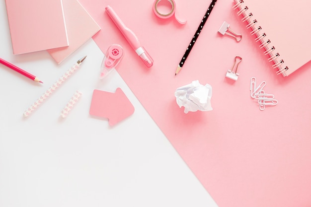 Flat lay of office stationery with paper clips and notebook