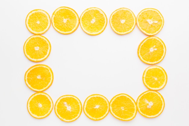 Free photo flat lay of orange slices frame concept