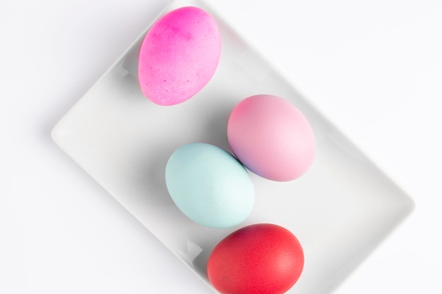 Free photo flat lay of painted easter eggs on plate