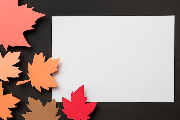 Free Photo flat lay paper autumn leaves composition on white paper