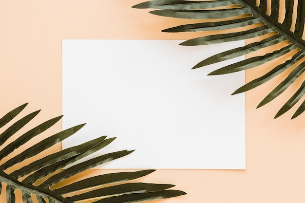 Flat lay of paper card template with leaves