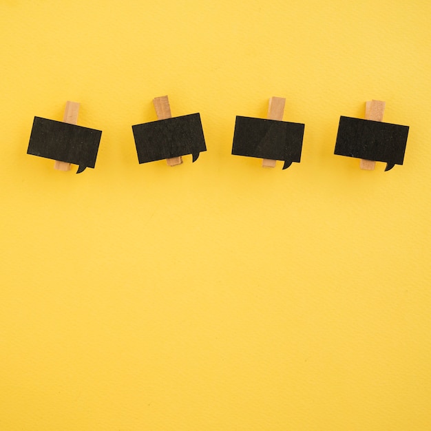 Flat lay of paper clips on yellow background