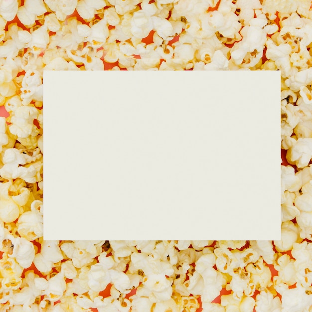 Free photo flat lay of paper on popcorn for cinema concept