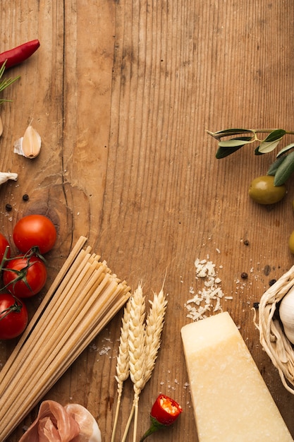 Flat lay pasta ingredients on table with copy space